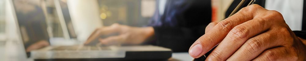 Business concept. Business people discussing the charts and graphs showing the results of their successful teamwork. Selective focus.